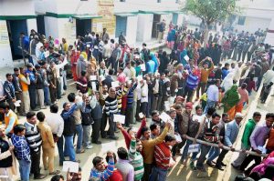 Voters stand in queue to cast their vote during the second phase of UP assembly polls in Moradabad. Source PTI